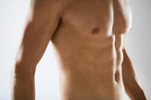 Close-up of male chest and midsection, concept of body care, fitness, and masculine physique