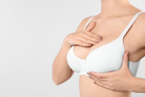 A close-up shot of a woman in a white bra after a breast lift in Dallas, TX